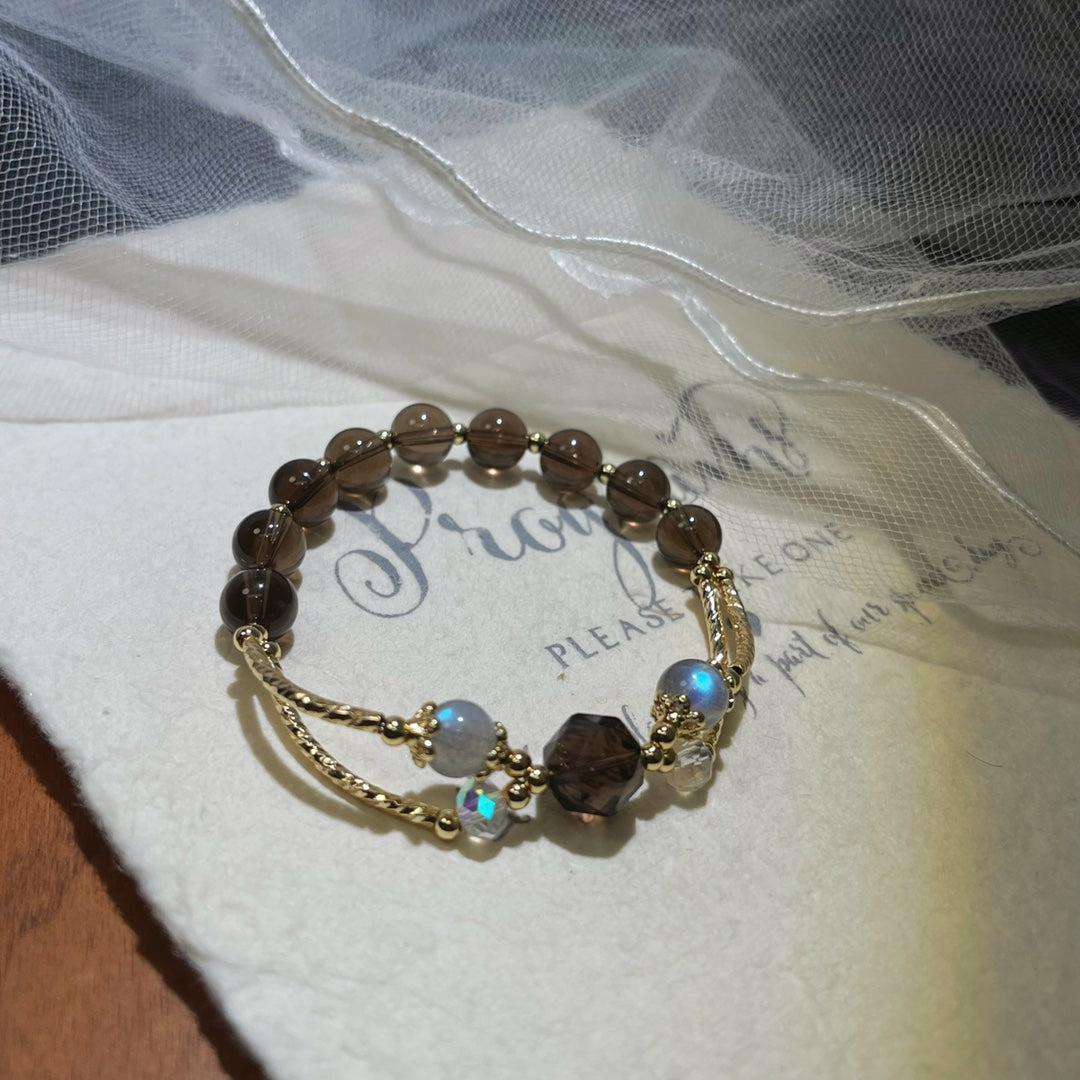 Wearing moonstone and obsidian crystal bracelet for emotional healing