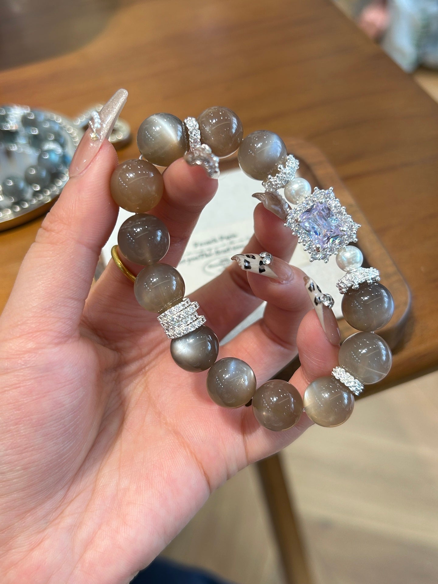 Close-up of gray moonstone beads with crystal and pearl accents