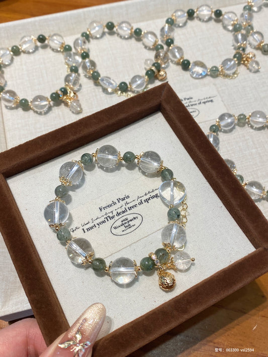 Clear quartz and green rutilated quartz bracelet with gold charm – designed to support clarity, career focus, and emotional balance.